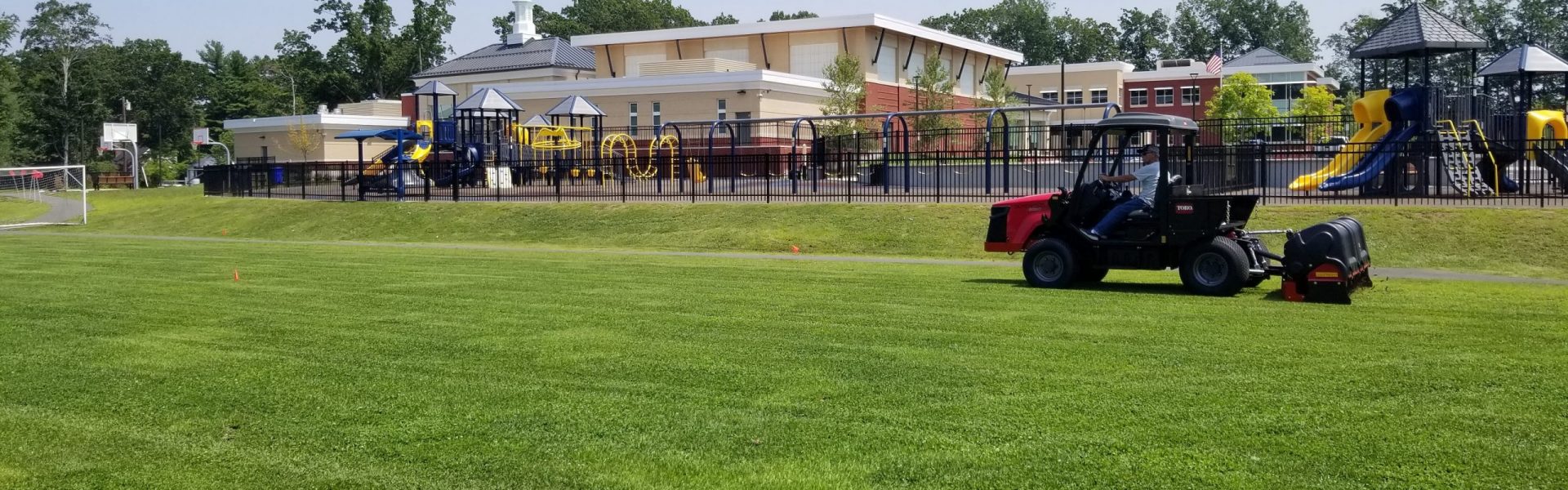 athletic fields on school grounds with tractor