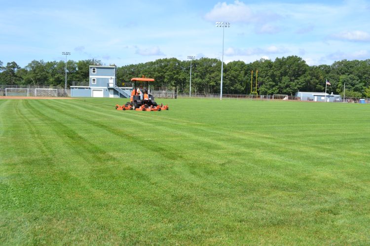 turfgrass field being mowed
