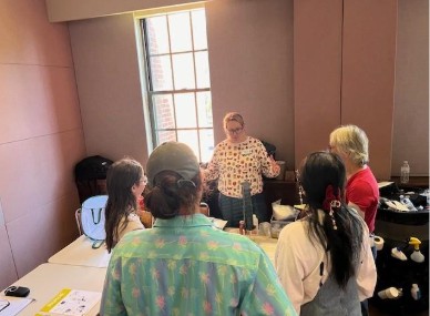 A group of people sitting at a table at a full day Biological Control Conference for a presentation Bug Math: Counting your tiny workforce