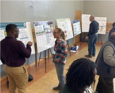 Participants at the 2025 UConn Extension’s Vegetable and Small Fruit Growers’ Conference and Tradeshow speak while looking at posters